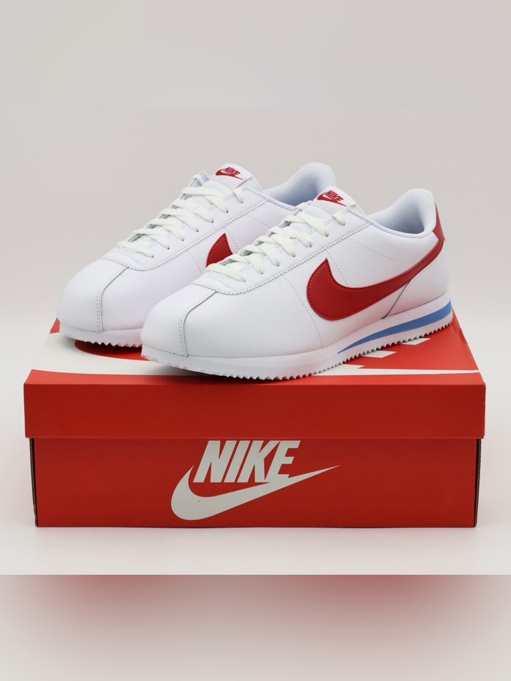 Nike Women’s White Sneaker with Red Swoosh and Blue Accent
